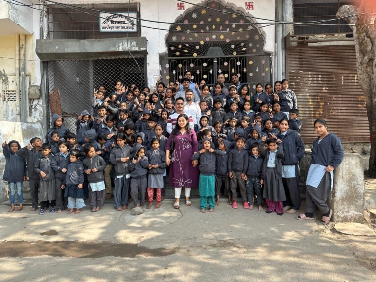 EXP team members with schoolchildren during a community visit